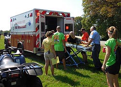 [photo, Baltimore City Fire Department personnel assisting injured football player, Patterson Park, Baltimore, Maryland]